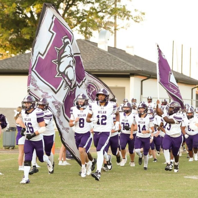 The Milan Bulldogs run onto the field before playing South Side in Week 1 action of the 2026 season.