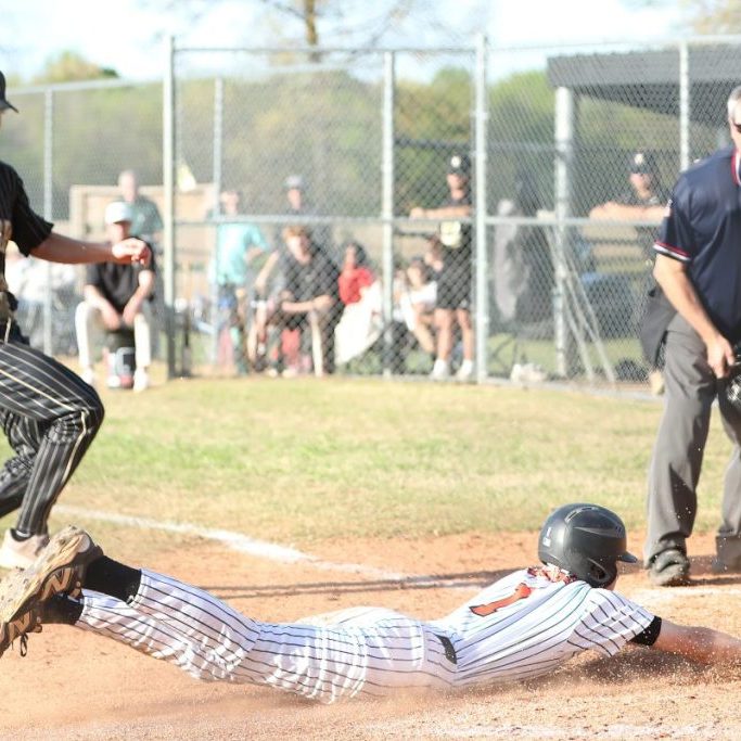 Greenfield's Baker Biggs (1) slides into home plate safely against Dresden during a District 14-1A high school baseball game at Callins Field on April 7, 2026.